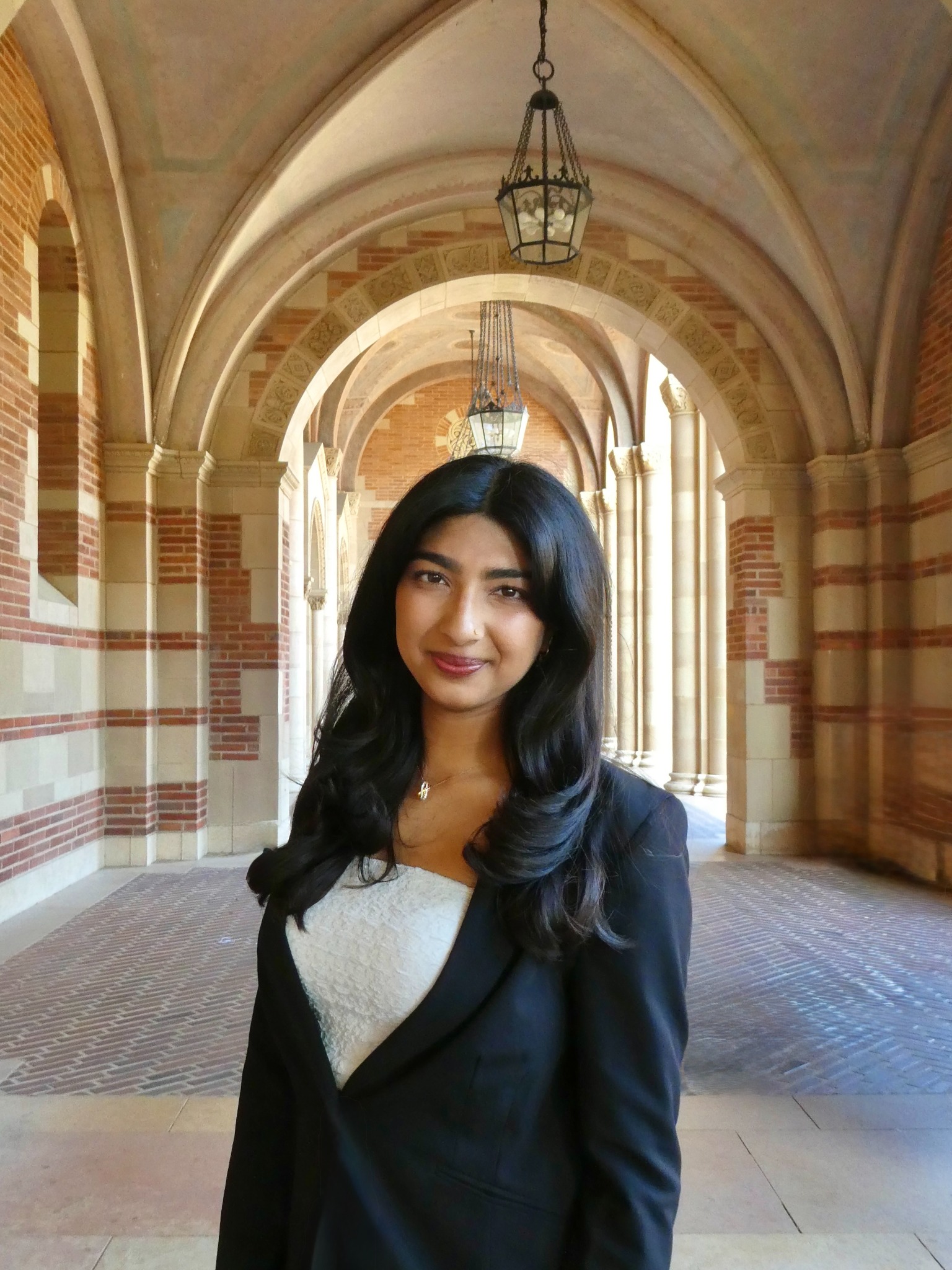 Janani Manathattai standing under the UCLA Royce Hall arches